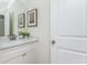 Small bathroom with white vanity, quartz countertop, and a framed print at 3910 Cameron Ct, Cumming, GA 30040