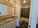 Modern bathroom with granite countertop, white cabinets, and a walk-in shower at 5981 Brundage Ln, Norcross, GA 30071