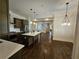 Open kitchen features an island and hardwood floors, offering views into the living area at 5981 Brundage Ln, Norcross, GA 30071
