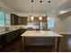 Spacious kitchen with island, stainless steel appliances, and dark wood cabinets at 5981 Brundage Ln, Norcross, GA 30071
