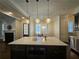 Kitchen with large island, stainless steel appliances, and hardwood floors at 5981 Brundage Ln, Norcross, GA 30071