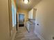 Convenient laundry room with utility sink, cabinets, and tile flooring at 5981 Brundage Ln, Norcross, GA 30071