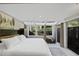Spacious primary bedroom with large windows and garden views at 141 Maison Nw Pl, Atlanta, GA 30327