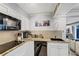 Modern kitchen with granite countertops and black appliances at 141 Maison Nw Pl, Atlanta, GA 30327