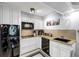 Modern kitchen with granite countertops and black appliances at 141 Maison Nw Pl, Atlanta, GA 30327