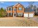 Brick two-story house with attached two-car garage and manicured lawn at 3904 Landmark Dr, Douglasville, GA 30135