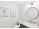 Stylish powder room with a gray vanity and a large round mirror at 4657 Jefferson Township Ln, Marietta, GA 30066