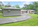 Back exterior of the home with green grass and mature trees at 4847 Lakewood Dr, Acworth, GA 30101