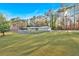 A long shot of a house with a large front yard surrounded by trees at 4847 Lakewood Dr, Acworth, GA 30101