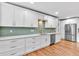 Modern kitchen featuring white cabinetry, stainless steel appliances, and stylish backsplash at 4847 Lakewood Dr, Acworth, GA 30101