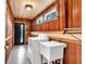 Well-lit laundry room with wood paneled walls, updated appliances, and convenient sink at 4847 Lakewood Dr, Acworth, GA 30101