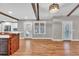 Open living room with hardwood floors, wooden beams, and doors leading to a backyard at 4847 Lakewood Dr, Acworth, GA 30101