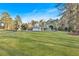 Expansive front yard view of a home surrounded by mature trees at 4847 Lakewood Dr, Acworth, GA 30101