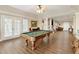 Basement game room with pool table and hardwood floors at 820 Hedgegate Ct, Roswell, GA 30075