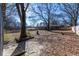 Spacious backyard, partially fenced, with mature trees and a shed at 850 Briarwood Trl, Douglasville, GA 30134