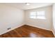Simple bedroom with hardwood floors and two large windows at 850 Briarwood Trl, Douglasville, GA 30134