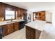 Kitchen with island, stainless steel appliances and wood cabinets at 850 Briarwood Trl, Douglasville, GA 30134