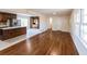 Open concept kitchen and dining area with hardwood floors, an island, and dark wood cabinets at 850 Briarwood Trl, Douglasville, GA 30134