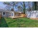 A backyard featuring a wooden deck, a privacy fence, a shed, and a grass lawn at 1268 Kenilworth Sw Dr, Atlanta, GA 30310