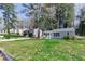 Exterior view of a single-Gathering home with well-kept lawn and surrounded by mature trees at 1268 Kenilworth Sw Dr, Atlanta, GA 30310