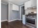 Well-equipped kitchen with stainless steel gas range and microwave, plus sleek white cabinetry at 1268 Kenilworth Sw Dr, Atlanta, GA 30310