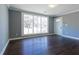 A light-filled living room with hardwood floors, gray walls, and large window offering views of the outside at 1268 Kenilworth Sw Dr, Atlanta, GA 30310