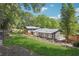 Beautifully landscaped backyard with a modern home featuring a wooden deck and lush greenery at 2139 Cedarbrook Se Ct, Atlanta, GA 30316