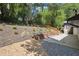 Landscaped backyard with wooden retaining wall and decorative lighting, creating a tranquil outdoor space at 2139 Cedarbrook Se Ct, Atlanta, GA 30316