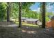 Spacious backyard featuring mature trees, a wooden fence, and modern home design at 2139 Cedarbrook Se Ct, Atlanta, GA 30316
