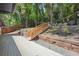 Expansive deck with wooden stairs and retaining wall, offering a seamless transition to the lush backyard at 2139 Cedarbrook Se Ct, Atlanta, GA 30316