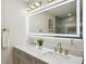 Bathroom featuring double vanity, illuminated mirror, contemporary fixtures, and neutral color palette at 2139 Cedarbrook Se Ct, Atlanta, GA 30316