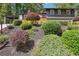 View of the exterior showcasing a beautifully landscaped front yard with a well-maintained lawn and mature trees at 2139 Cedarbrook Se Ct, Atlanta, GA 30316