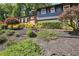 Home's front yard features lush landscaping, manicured bushes, and a brick-lined garden at 2139 Cedarbrook Se Ct, Atlanta, GA 30316