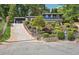 Charming two-story house with lush landscaping, a long driveway, and a quaint mailbox at 2139 Cedarbrook Se Ct, Atlanta, GA 30316