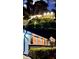Multi-level home with beautifully landscaped yard, attractive lighting, and a welcoming front entrance at 2139 Cedarbrook Se Ct, Atlanta, GA 30316