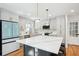 Well-lit kitchen featuring a marble countertop island with pendant lights, stainless appliances, and ample cabinet space at 2139 Cedarbrook Se Ct, Atlanta, GA 30316