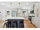 Stylish kitchen boasts elegant pendant lighting, white cabinetry, marble countertops, and stainless steel appliances at 2139 Cedarbrook Se Ct, Atlanta, GA 30316