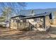 Exterior view of home's backyard featuring a wooden deck and mature trees at 6615 Buckhurst Trl, Atlanta, GA 30349