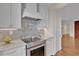 Modern kitchen features white cabinets, granite countertops and a white range hood at 750 Park Ne Ave # 6E, Atlanta, GA 30326