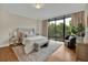 Spacious main bedroom with a plush bed, hardwood floors and access to a balcony at 750 Park Ne Ave # 6E, Atlanta, GA 30326