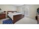 Spacious bedroom with wooden sleigh bed and carpet at 4414 Parmalee Path, Conley, GA 30288