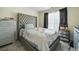 Cozy bedroom with a tufted headboard and large window at 4414 Parmalee Path, Conley, GA 30288