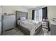 Bedroom with gray upholstered bed and window at 4414 Parmalee Path, Conley, GA 30288