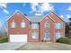 Two-story brick home with a two-car garage and nicely landscaped yard at 4414 Parmalee Path, Conley, GA 30288