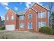 Brick house with blue door and shutters, two-car garage, and landscaped lawn at 4414 Parmalee Path, Conley, GA 30288