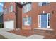 Front entrance with blue door, brick steps, and neatly maintained landscaping at 4414 Parmalee Path, Conley, GA 30288