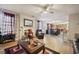 Open living space with a fireplace, hardwood floors, and access to the kitchen at 4414 Parmalee Path, Conley, GA 30288