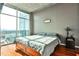 Bright bedroom with hardwood floors, large windows, and city views at 250 Pharr Rd # 712, Atlanta, GA 30305