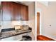 Small kitchen area with granite countertop and built-in shelving at 250 Pharr Rd # 712, Atlanta, GA 30305