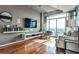 Modern living room with hardwood floors and floor to ceiling windows at 250 Pharr Rd # 712, Atlanta, GA 30305